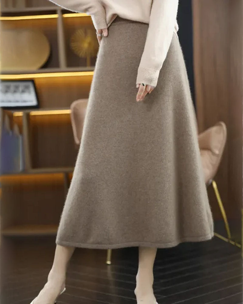 Woman twirling in a 100 % Wool Knitted A-Line Skirt, 19.5-micron superfine Merino rib and midi flare give vintage polish—your wind-proof 45-65 °F fall-through-spring essential.