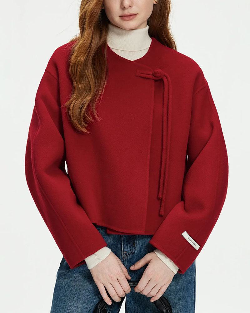 Woman commuting in a camel 100 % wool short double-sided coat, 18-inch length and raw-edge seams deliver minimalist structure while locking in warmth for 35-55 °F fall days.