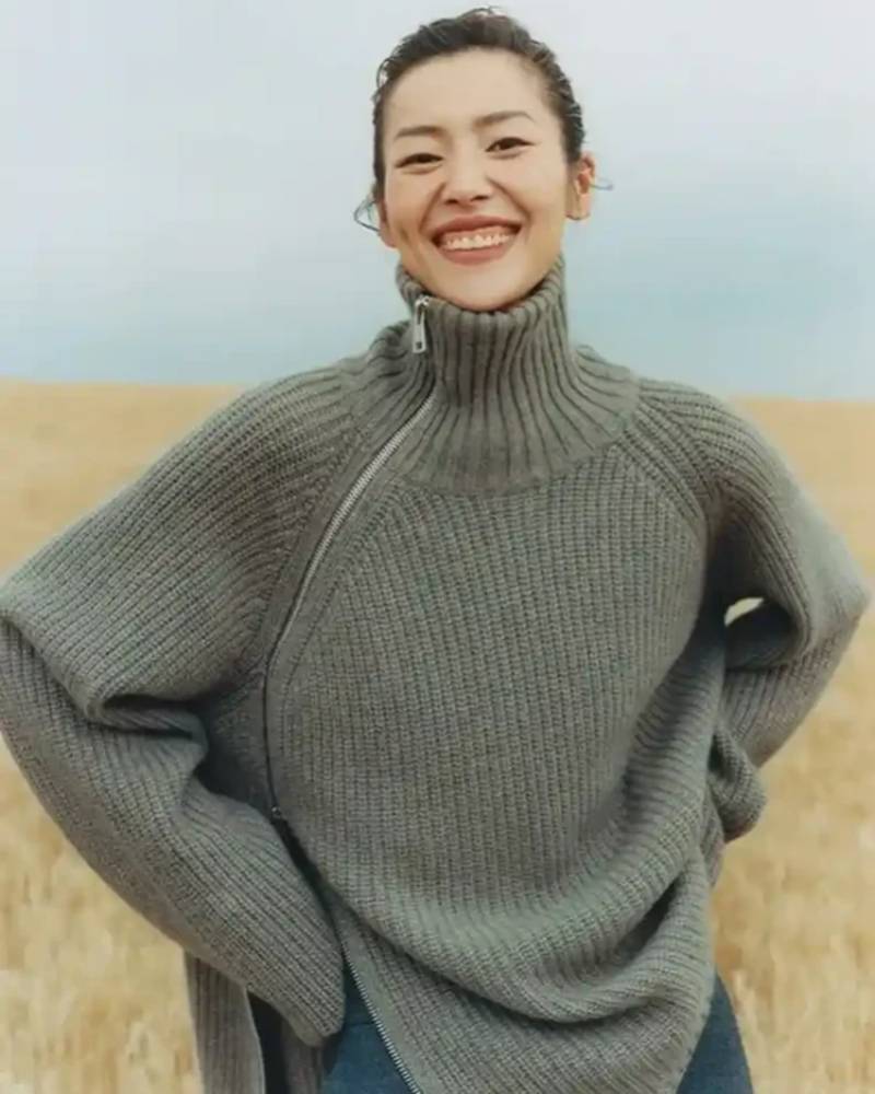 Oversized 100 % cashmere sweater, irregular diagonal zipper at high neck, dropped shoulders, ribbed cuffs, heather taupe—runway-ready winter layer for him or her.