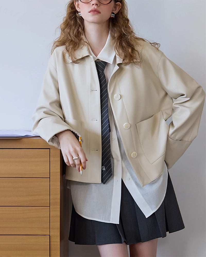 Woman street-styling the Retro Single-Breasted PU Leather Jacket, 100 % polyester faux leather in coffee-brown, notched lapels and single-breasted close give vintage 90s attitude—lightweight wind-proof layer for 60-75 °F spring-fall commutes.