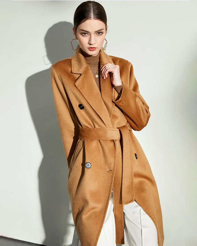 Woman gliding through winter in a water-ripple double-sided 100 % wool coat, midi length and fluid lapels trap heat down to 0 °C—elegant outerwear for boardroom or boulevard.
