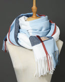 Woman wrapping the Big Plaid Wool-Blended Scarf with Fringed ends, 90 × 200 cm brushed wool-blend plaid and hand-tied fringe give heritage charm—your wind-proof 35-55 °F fall-through-spring wrap that doubles as a blanket on long flights.