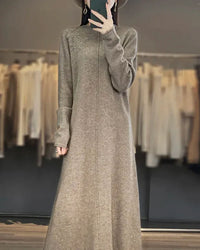 Woman posing in a Cashmere and Wool Knitted Long Dress, 70 % wool / 30 % cashmere rib drapes like jersey—your luxe yet breathable 60-75 °F spring-fall statement.