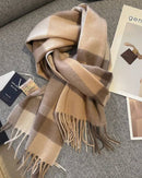 Oversized checked 100 % wool scarf, classic tartan, hand-tied fringed edges, soft camel & navy—winter wrap that elevates coats or knitwear.