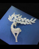 Sparkling silver-tone reindeer brooch pin paved with clear rhinestones, festive holiday accent for coats, scarves or stockings.