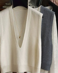Woman layering a sand-beige deep-v-neck wool vest, 19.5 micron superfine knit and wide lapels give minimalist 90s vibes—your breathable 60-75 °F spring-fall layer.