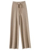 100 % cashmere wide-leg pants, drawstring waist, floor-skimming drape, heather taupe—cloud-soft luxury for winter lounging or city outings.