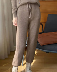 Woman heading to work in High-Waist Drawstring Wool Knitted Pants, 90 % wool / 10 % cashmere rib drapes like jersey—your polished yet cozy 45-65 °F fall-to-spring commuter layer.