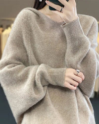 Woman street-styling a Hooded 100 % Wool Knitted Sweater, 19.5 micron superfine Merino drapes like jersey—your cozy yet breathable 45-65 °F fall-to-spring layer.