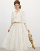 Woman brunching in a pastel lantern-sleeves V-neck strappy dress, airy 100 % rayon flows with every step—your feminine statement for 70-85 °F spring-summer days.