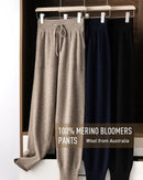  Woman lounging in Mid-Rise Merino-Wool Joggers, 100 % superfine Merino rib and relaxed bloomers silhouette keep you cozy yet breathable—your polished 45-65 °F fall-through-spring staple.