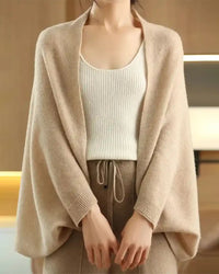 Woman layering a sand-beige Multifunctional Wool Knitted Shawl Scarf, 100 % superfine wool and 90 × 200 cm dimensions drape like a cloud—your cozy yet breathable 45-65 °F fall-to-spring wrap that doubles as a blanket on long flights.