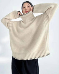 Cloud-soft oversized wool turtleneck sweater, slouchy drop shoulders, oatmeal marl—winter-ready layer for him or her.