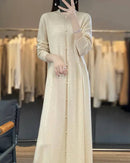 Oversized button-detailed cashmere dress, relaxed A-line silhouette, matte horn buttons down the side, midi length, soft camel—effortless winter luxury for her .