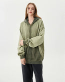 Woman layering an oversized cotton zipper washed hoodie, dropped shoulders and acid-wash finish give 90s street-style vibes—perfect lightweight layer for 60-75 °F spring-fall days.