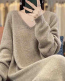 Woman posing in a Pure-Wool V-Neck Long-Sleeved Dress, 100 % superfine Merino drapes like jersey—your luxe yet breathable 45-65 °F fall-through-spring statement.