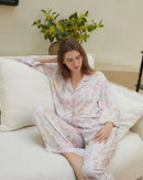 Soft rayon-satin pajama set with vibrant floral print, short-sleeve button-up top and elastic waist pants keep you cool and chic through warm summer nights.