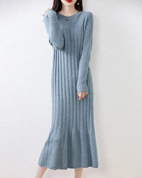  Woman posing in the Round-Neck Long-Sleeves Wool Dress, 19.5-micron 100 % Merino rib drapes like jersey—your luxe yet breathable 45-65 °F fall-through-spring statement.