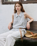 Woman styling a sand-beige ruching-detail textured blouse, subtle crinkles and front gathers add tactile depth—pair with tailored pants for effortless desk-to-dinner elegance.