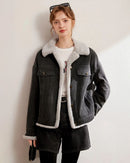 Woman layering a thickened fleece-lined denim jacket, vintage wash outside and plush shearling inside—wind-proof warmth for 30-50 °F fall-to-winter weekends.