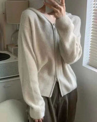 Woman city-strolling in a Zipped Wool Hoodie Short Coat, 100 % superfine Merino drapes like jersey—your luxe yet cozy 45-65 °F fall-through-spring essential.